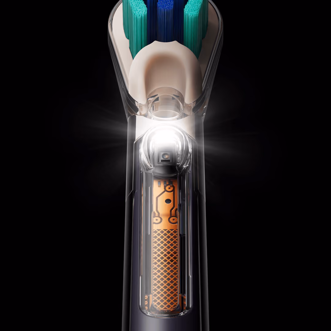 Inside the brush neck: the camera module lit up behind the clear housing